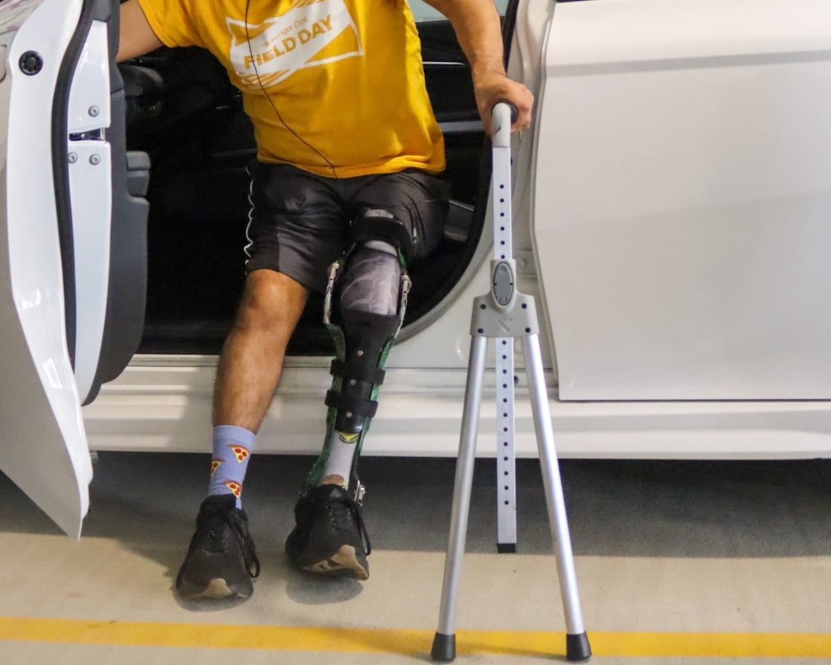 Person using the Cargility vehicle handrail for added stability